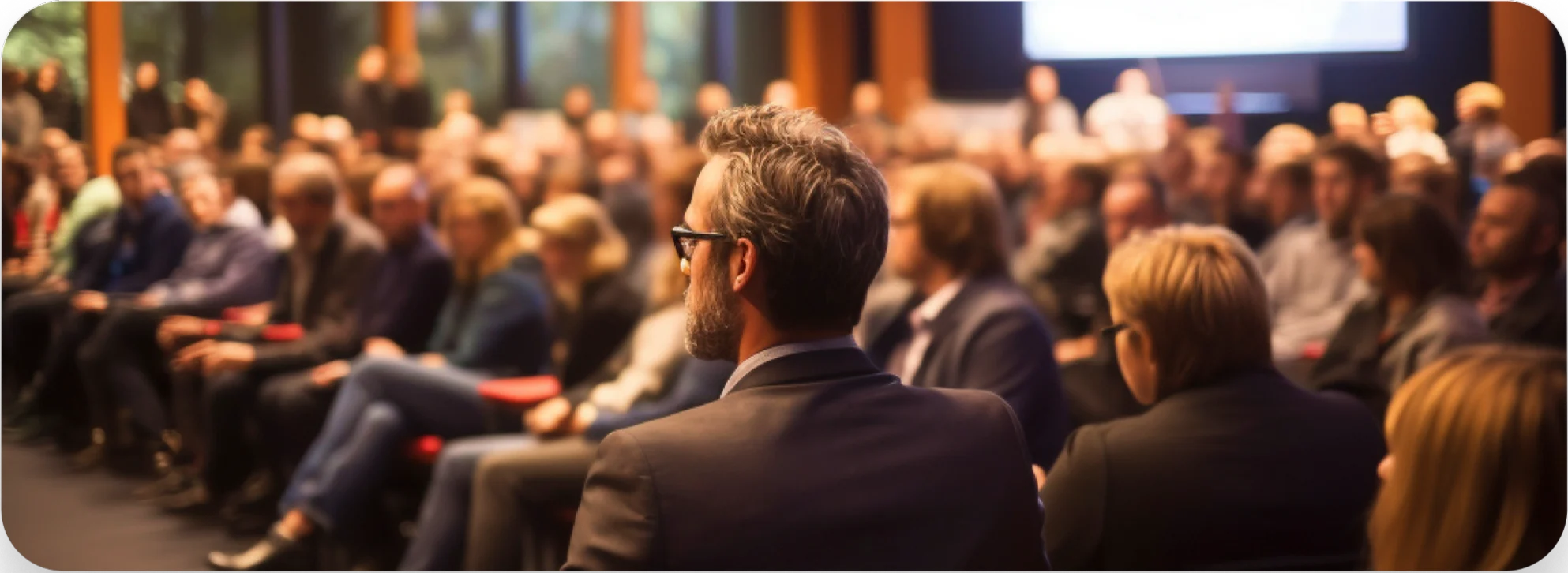 Audience members listening intently at a business conference seminar