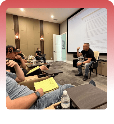 Gene Slade presenting to an audience during a training seminar inside a red graphic frame